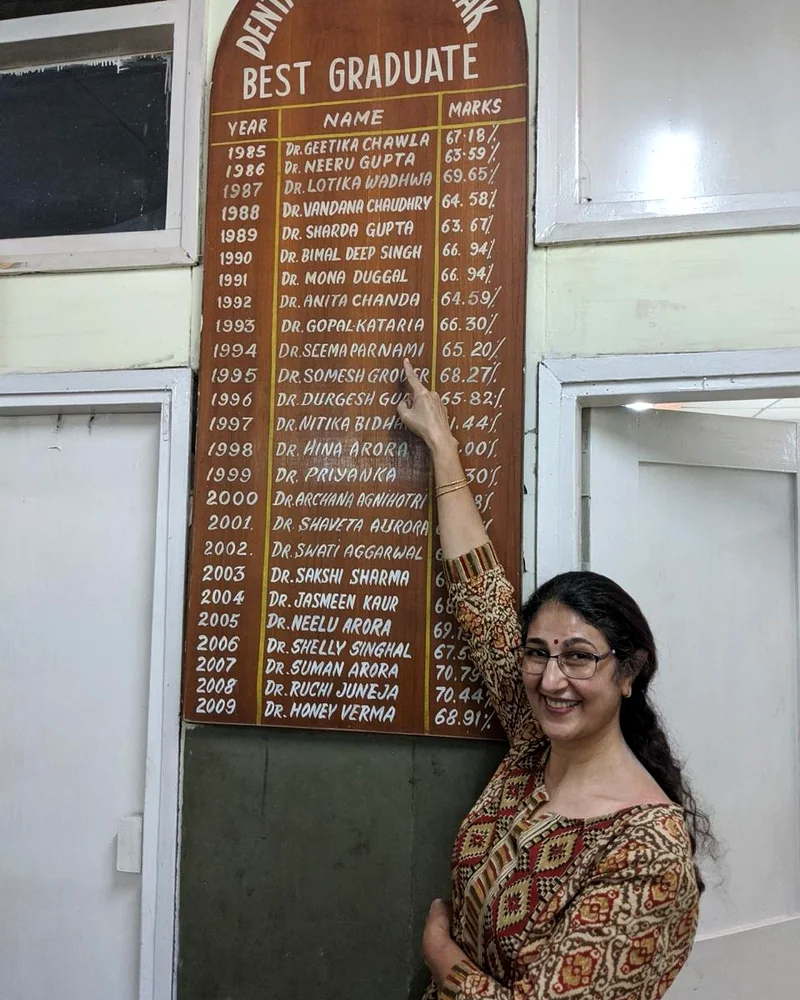 Dr. Prabhakar beside the Best Graduate honours board at Dental College, Rohtak