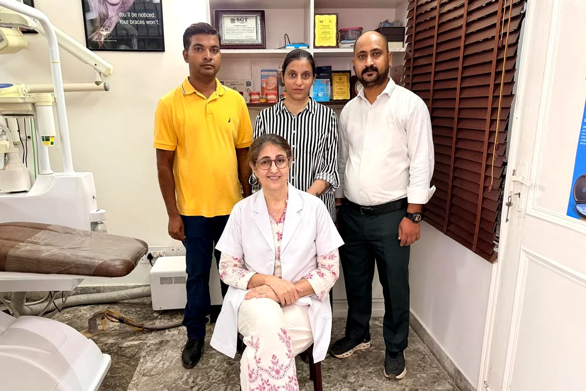 Dr. Mona Prabhakar seated with the team at her orthodontic clinic in Sector 31, Gurugram
